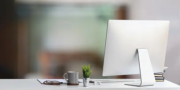 A small office desk with a computer